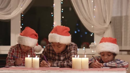 Three Children Writing Christmas Letters at Night
