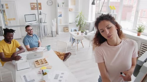 Colleagues Collaborating in Modern Open Office Space