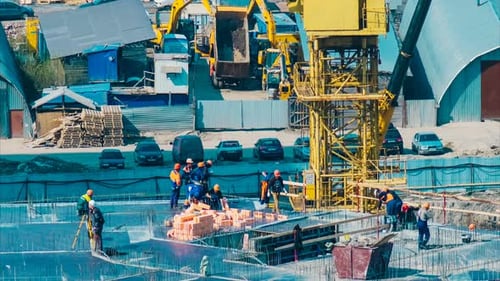 Yellow Cranes and Professionals in Uniforms with Logo Work