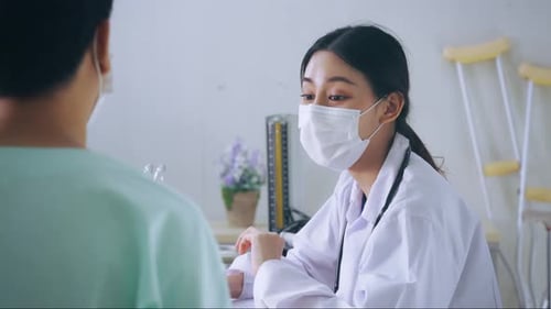 Doctor Examining Patient in Hospital with Stethoscope