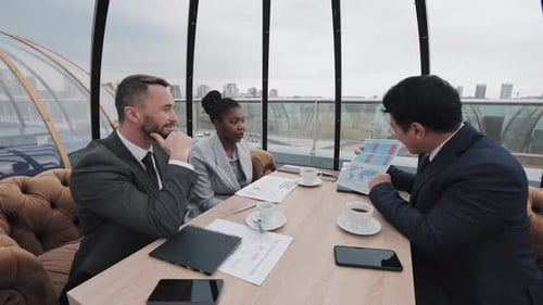 Diverse Colleagues Working in Cafe