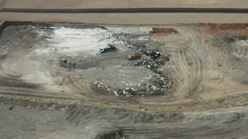 Aerial View of City Landfill With Trucks and Bulldozer