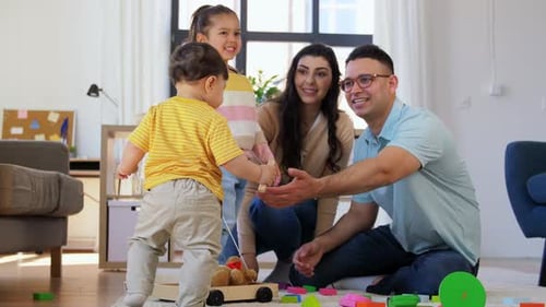 Glückliche Familie mit Kindern, die zu Hause spielen