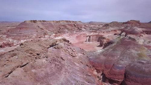Aerial view over color desert terrain