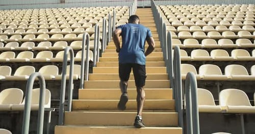 Anonymous Black Sportsman Running on Steps
