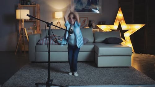 Energetic Girl Singing into Microphone in Living Room