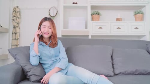 Cheerful Woman Talking on Phone on Couch