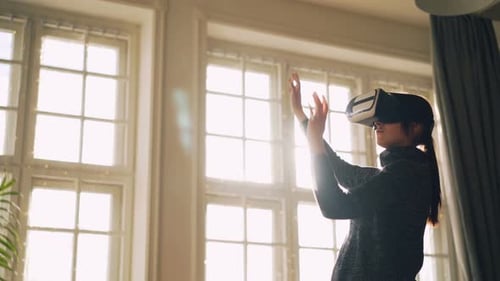 Young Woman Uses VR Headset in Bright Room