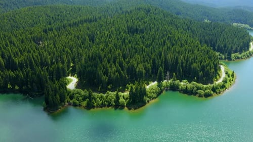 Aerial view over beautiful mountain road with turquoise lake and green forest. Baikal Lake Siberia