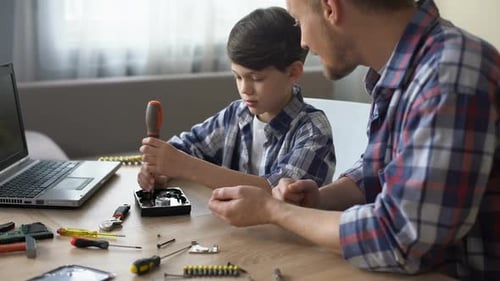 Caring Father Teaching His Little Son to Repair Hard Disk Drive at Home, Hobby