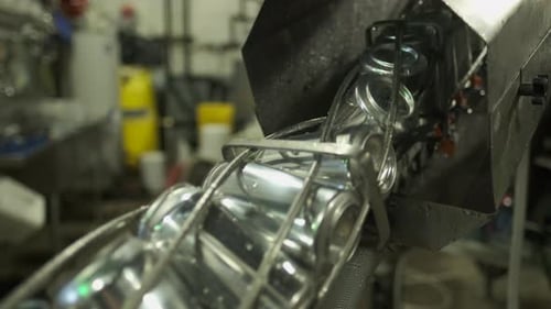 Cans Moving Along Factory Conveyor Belt
