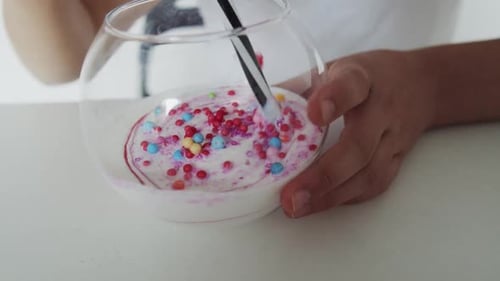 Close Up View of Girl's Hands Who Make a Colourful Slime