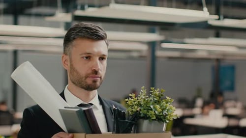 Frustrated Fired Man Walking Holding Cardboard Box Leaving Modern Office