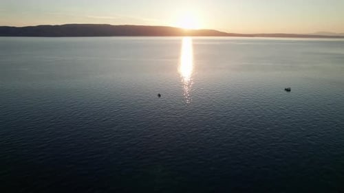 Aerial View of Landscape Sunset Over the Sea Leaves Trail and Glare on the Water