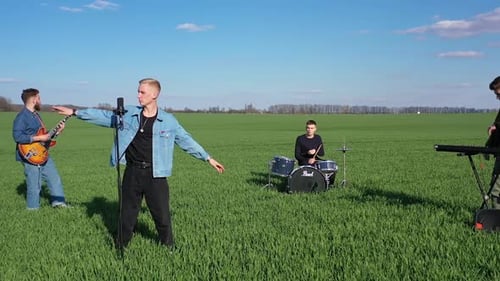 Band Playing Music in a Green Field