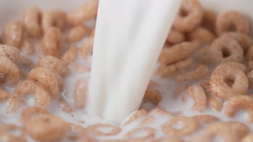 Milk Being Poured into a Bowl of Cereal