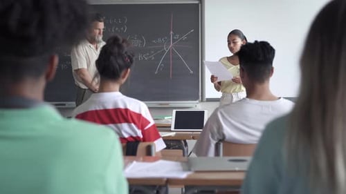 Latin Female High School Student Presenting a Project or Reading a Composition to Classmates and