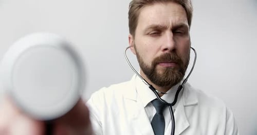 Portrait of Bearded Doctor Using Stethoscope