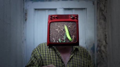 Man with TV Head Displaying Green Vegetable