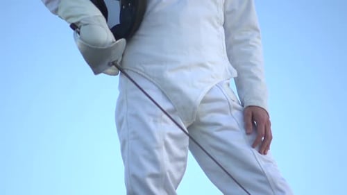 A man fencing on the beach
