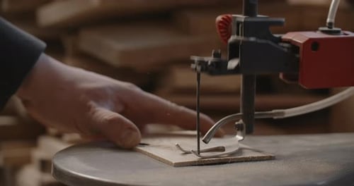 Woodworking at the Workshop Carpenter Uses Automatic Jigsaw and Cuts Small Plywood Parts