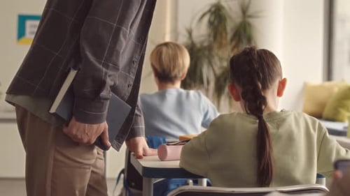 School Teacher Helping Student during Test
