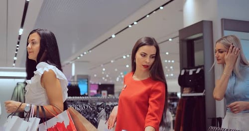 Three Women Shopping for Clothing in Department Store