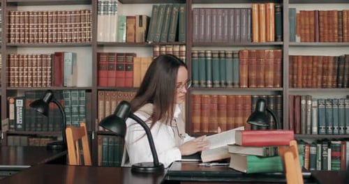Girl Reading Book in Library