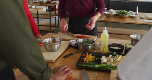 Cooking Class Students Learning to Chop Vegetables