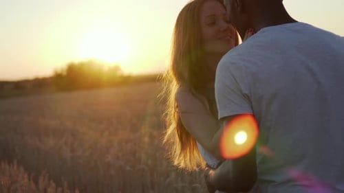 Interracial Couple Kissing at Sunset