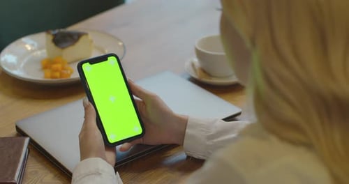 Closeup of Woman Hand is Holding Chroma Key Green Screen with Touching