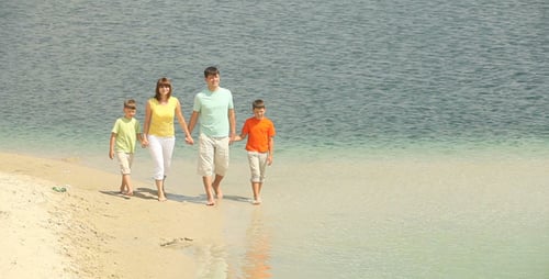 Family Enjoying Sunny Beach Walk on Vacation