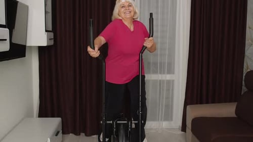 Senior Woman Exercising on Elliptical at Home