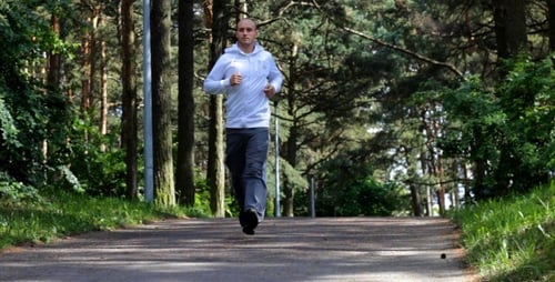 Handsome Young Sportsman Jogging In The Park