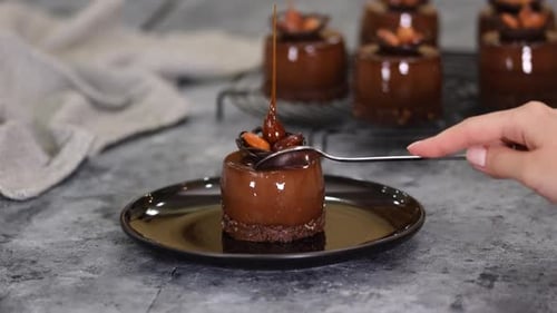 Cutting into Chocolate Dessert Mousse Cake with Spoon