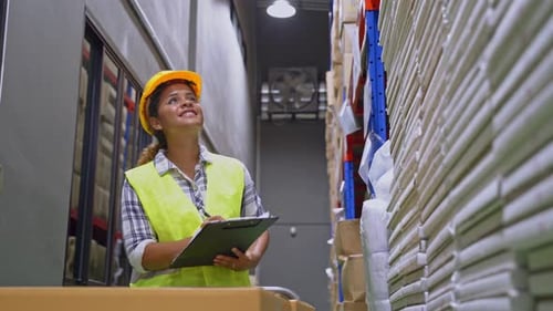 Young smiling black woman worker checking box shipping goods and packaging products to customer.