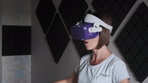 Woman Using VR Headset and Controllers Indoors