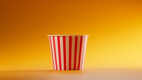 Realistic Popcorn Filling a Striped Cup Animation