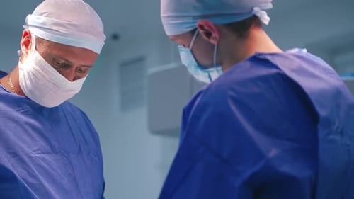 Surgeons operating patient at hospital. Surgical team during operation in surgery environment