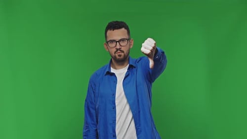 Man Gives Thumbs Down on Green Screen