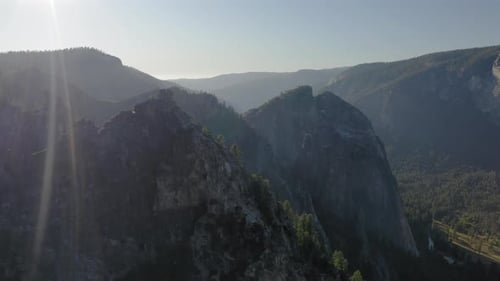 Scenic Aerial Survey Over the Yosemite National Park Lit with Bright Sunset Rays