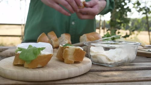 Preparing Gourmet Sandwiches Outdoors with Fresh Ingredients