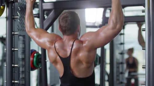 Man Doing Pull Ups in Gym