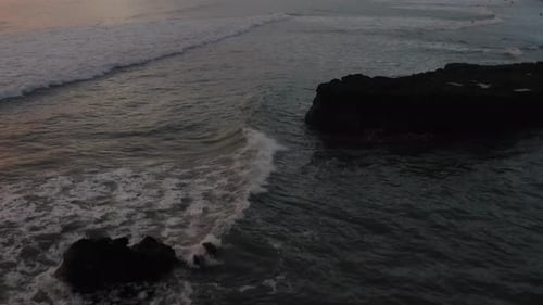 Flight Over Surfers Surfing Ocean Waves at Sunset