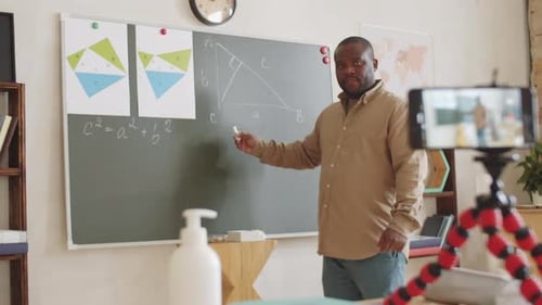 Afro-American School Teacher Educating Online via Video Call on Phone