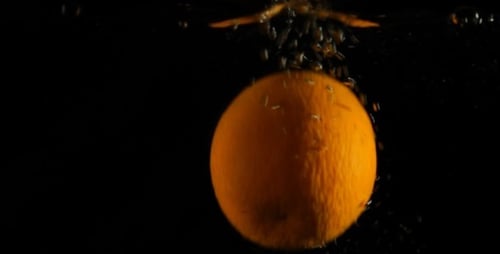 Orange Splashing into Water in Slow Motion