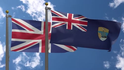 Waving United Kingdom and Saint Helena Flags against Blue Sky