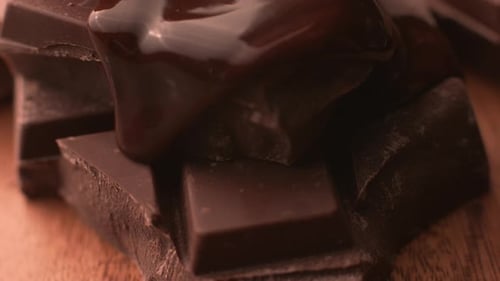 Melted chocolate pouring over chunks of chocolate in super slow motion, shot on Phantom Flex 4K