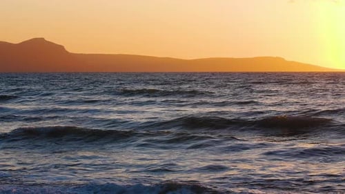 Natural Dramatic Seascape Sunrise with Mountains Sunset Sun Shining Through Golden Waves Ocean and