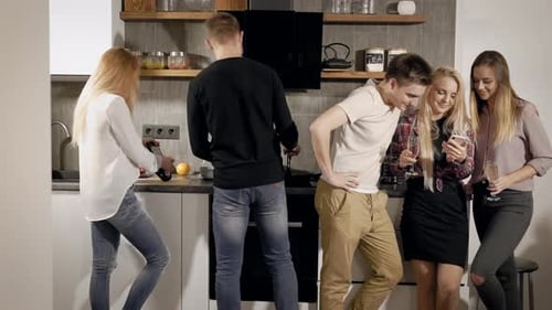 Group of Friends Celebrating in Modern Kitchen